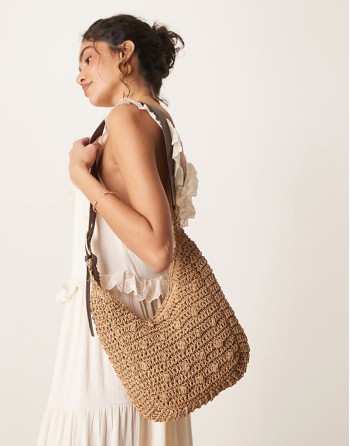 curved rafia shoulder bag with buckle strap in beige