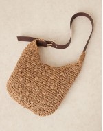 curved rafia shoulder bag with buckle strap in beige