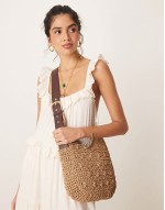 curved rafia shoulder bag with buckle strap in beige