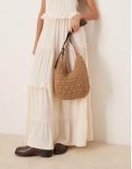 curved rafia shoulder bag with buckle strap in beige
