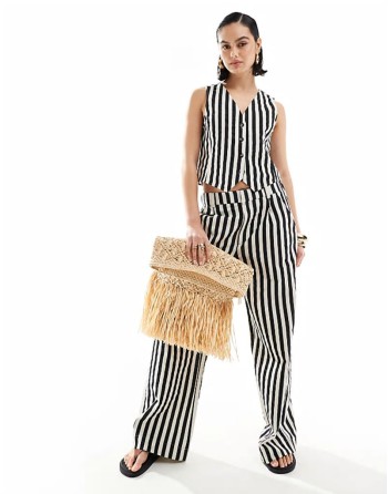 oversized straw clutch with fringe detail in natural