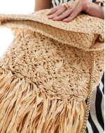 oversized straw clutch with fringe detail in natural